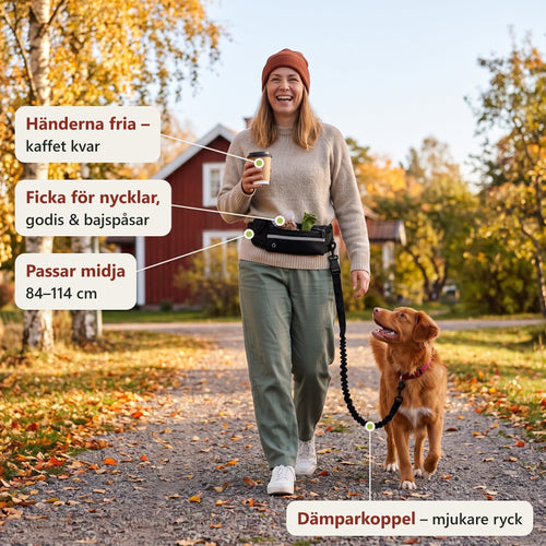 Glad kvinna på höstpromenad med kaffe i handen och svart handsfree-bälte runt midjan, tollaren går i dämparkopplet. Etiketterna visar händerna fria, fickan för nycklar, godis och bajspåsar, midjemåttet 84–114 cm och dämparkopplet